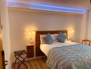 a bedroom with a bed with a blue light above it at The Old Printworks, Kirkwall in Orkney