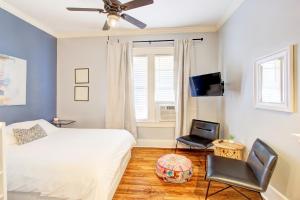 a bedroom with a bed and a chair and a window at Splendid Colonial in Midtown with Parking in Memphis