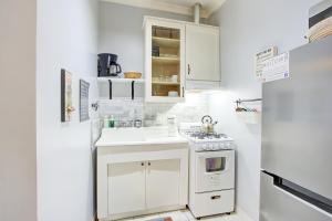 a small kitchen with a stove and a refrigerator at Splendid Colonial in Midtown with Parking in Memphis