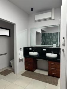 a bathroom with two sinks and a large mirror at Blue Wings Villa in Fortuna +43 photos