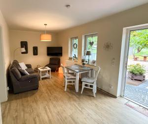a living room with a table and a couch at Ferienwohnungen Ast in Burg +38 photos