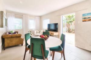a living room with a table and chairs at Stylish, Private, Thoughtful, Spotless, Aircon, Parking in Hermanus