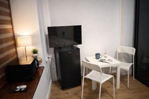 a small room with a small table and a television at Via Room in Raszyn