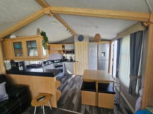 a kitchen and living room in a tiny house at V10 static caravan in Ingoldmells