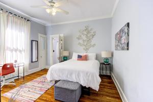 a bedroom with a bed and a ceiling fan at Unwind and Relax in a Historic Midtown Property in Memphis