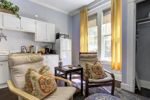 a kitchen with a couch and two chairs in a room at Unwind and Relax in a Historic Midtown Property in Memphis