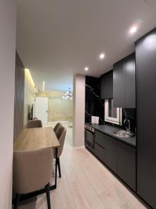 a kitchen and dining room with a table and chairs at Fabio Home in Tirana