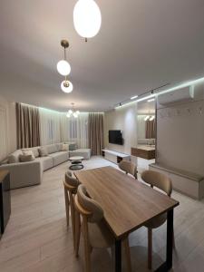 a living room with a table and a couch at Fabio Home in Tirana