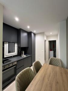 a kitchen with a wooden table and chairs at Fabio Home in Tirana +4 photos