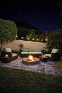 a fire pit in a yard with couches and torches at 3 Bedroom Family Home, Pool & Garden, Upper Constantia in Constantia