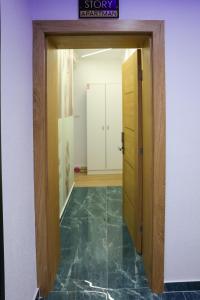 a hallway with a door open to a room at Foča Apartman STORY in Foča