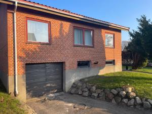 ein Backsteinhaus mit Garage in der Unterkunft Rødt hus in Givskud