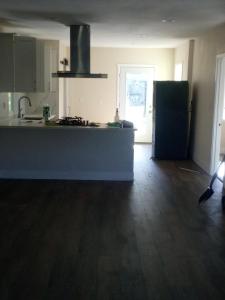a kitchen with a sink and a refrigerator in a room at Chill Rooms in Oakland