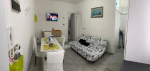 a living room with a couch and a table at Indy Sea Home in Lido degli Estensi
