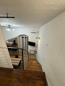 a room with a staircase with wooden floors and a television at Il Pilone in Barletta +8 photos