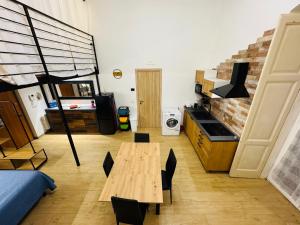 a room with a table and a bed and a kitchen at Il Pilone in Barletta