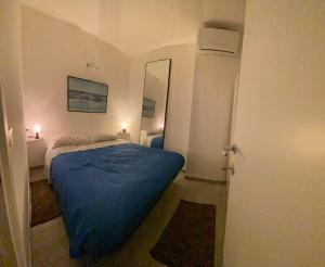 a small bedroom with a bed and a mirror at Indy Sea Home in Lido degli Estensi