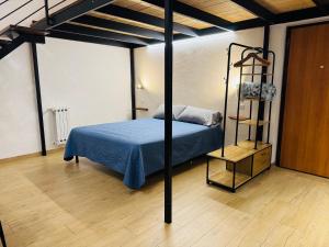 a bedroom with a bed with a blue comforter at Il Pilone in Barletta