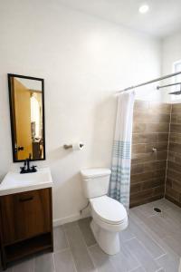 a bathroom with a toilet and a sink and a shower at Casa Laud playa ventura Boutique hotel in Playa Ventura