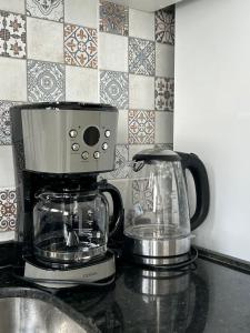 a coffee maker sitting on top of a counter at Divine Duplex Próximo ao Oficina 23 Kite Surf in Caucaia