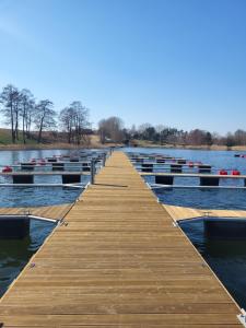 a dock on a lake with boats in the water at Ostoja Orli Dziób B2 in Kal