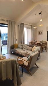 a living room with a couch and a table at Villa GEIA in Klísmata