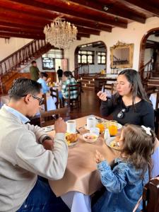 a group of people sitting around a table eating food at Andina Amazon Lodge in Chachapoyas
