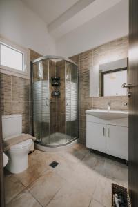 a bathroom with a shower and a toilet and a sink at Milto's Studios in Parga