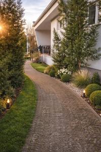 a cobblestone driveway in front of a house at Mierzyn Po Drodze in Mierzyn