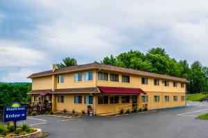 a large yellow building with a sign in a parking lot at Days Inn by Wyndham Wurtsboro in Wurtsboro