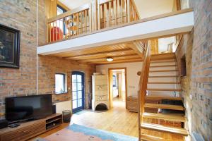 a loft conversion with a staircase and a living room at Blankenese in Ahlbeck