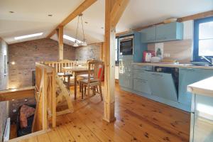 a kitchen with blue cabinets and a table with chairs at Blankenese in Ahlbeck