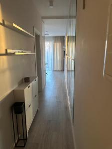 an empty room with a kitchen and a hallway at Fly & Pool Apartment in Palanga