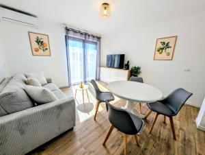 a living room with a couch and a table and chairs at La Régalide 2A in Roquebrune-Cap-Martin