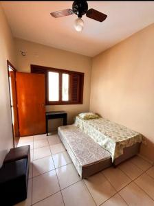 a bedroom with two beds and a ceiling fan at KS lazer e eventos in Ribeirão Preto +14 photos