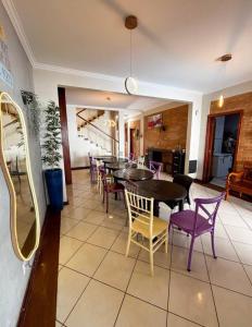 a dining room with tables and purple chairs at KS lazer e eventos in Ribeirão Preto