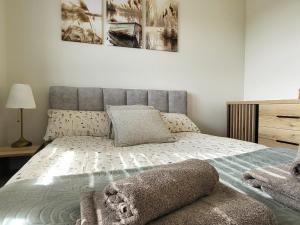 a bedroom with a bed with a gray headboard at Ostoja Orli Dziób B2 in Kal +34 photos