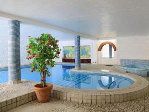 a large swimming pool with a plant in a room at Tuckenhay, Clock Tower Cottage - Fjg in Ashsprington