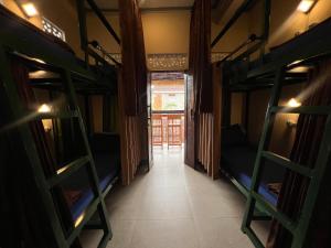 a corridor of a room with bunk beds at ERA Guest House in Ubud