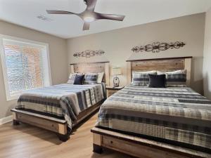 a bedroom with two beds and a ceiling fan at Serenity at the Summit in Gatlinburg