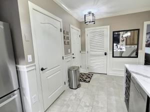 a kitchen with a white door and a trash can at Serenity at the Summit in Gatlinburg