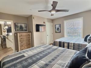 a bedroom with two beds and a ceiling fan at Serenity at the Summit in Gatlinburg +37 photos