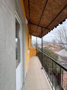 a balcony of a house with awning and a walkway at Odessky Dvorik in Chişinău