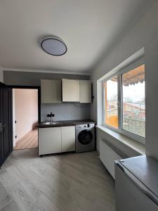a kitchen with a washer and dryer in a room at Odessky Dvorik in Chişinău +9 photos