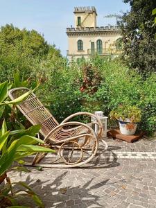 a bench sitting in a garden with a building in the background at Lemontree House Bacoli in Bacoli