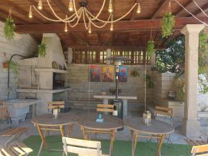 a patio with tables and chairs and a grill at Casa Quercus Galicia, a 17 minutos de Santiago! in A Estrada
