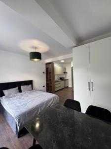 a bedroom with a bed and a dining table at Columna Home in Chişinău