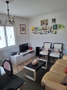 a living room with a couch and chairs and a tv at Mar de Pantin in Valdoviño
