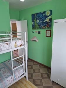 a room with a bunk bed and a refrigerator at Mar de Pantin in Valdoviño