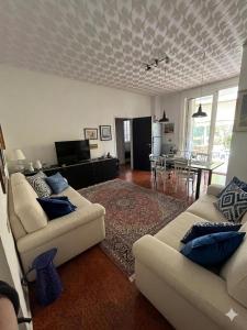 a living room with two couches and a dining room at La casa di Giò in Varazze